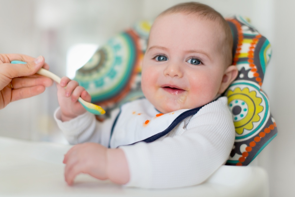 Cute baby eating puree