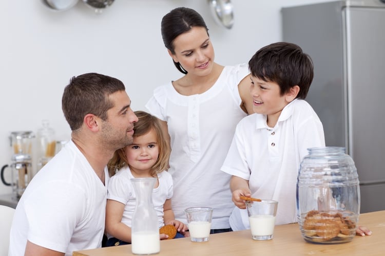 Parents and children drinking milk in the kitchen